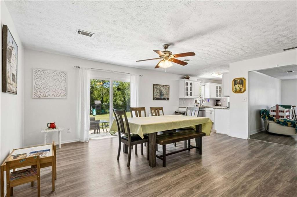 795 Tanner Road Dacula, GA 30019 - Photo 13 of 47 a view of a dining room with furniture and wooden floor
