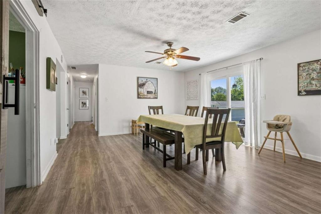 795 Tanner Road Dacula, GA 30019 - Photo 14 of 47 a view of a dining room with furniture and wooden floor
