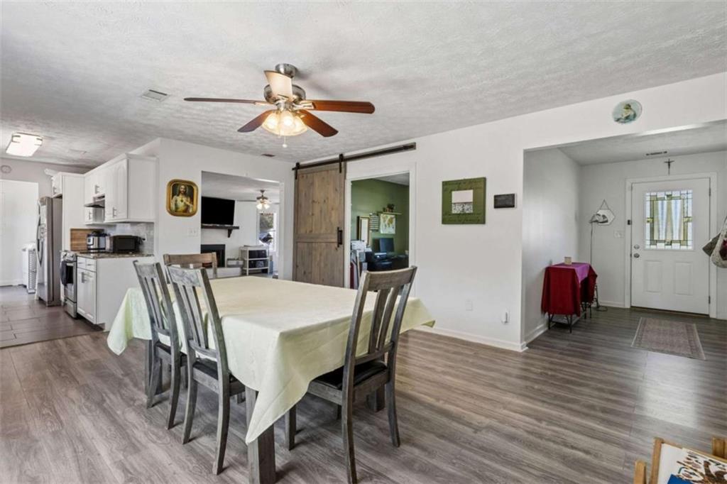 795 Tanner Road Dacula, GA 30019 - Photo 18 of 47 a view of a dining room with furniture and wooden floor