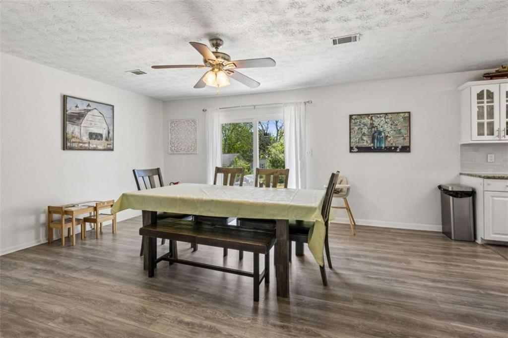 795 Tanner Road Dacula, GA 30019 - Photo 19 of 47 a view of a dining room with furniture window and wooden floor