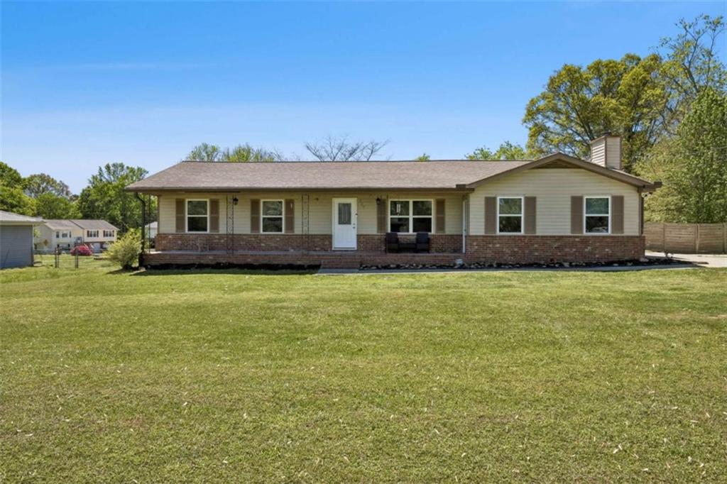795 Tanner Road Dacula, GA 30019 - Photo 3 of 47 a front view of a house with a garden