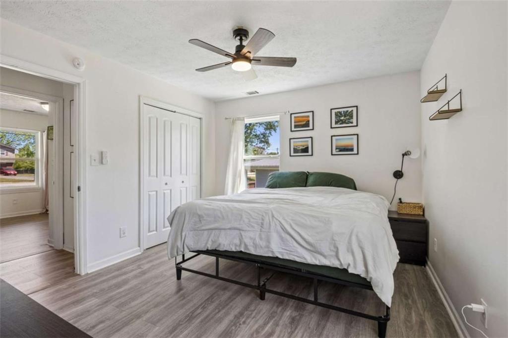 795 Tanner Road Dacula, GA 30019 - Photo 31 of 47 a spacious bedroom with a bed and a chandelier
