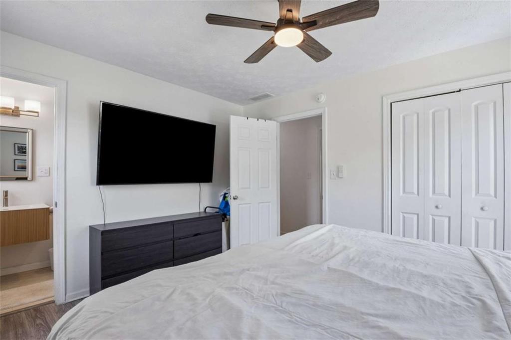 795 Tanner Road Dacula, GA 30019 - Photo 32 of 47 a bedroom with a bed and a flat screen tv