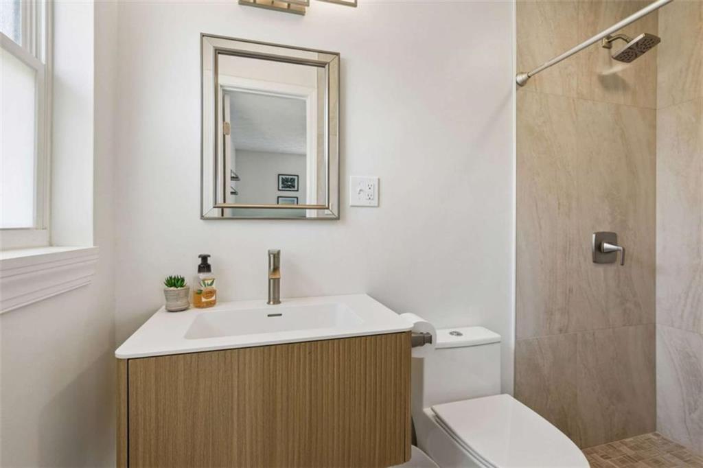 795 Tanner Road Dacula, GA 30019 - Photo 33 of 47 a bathroom with a sink a toilet and shower