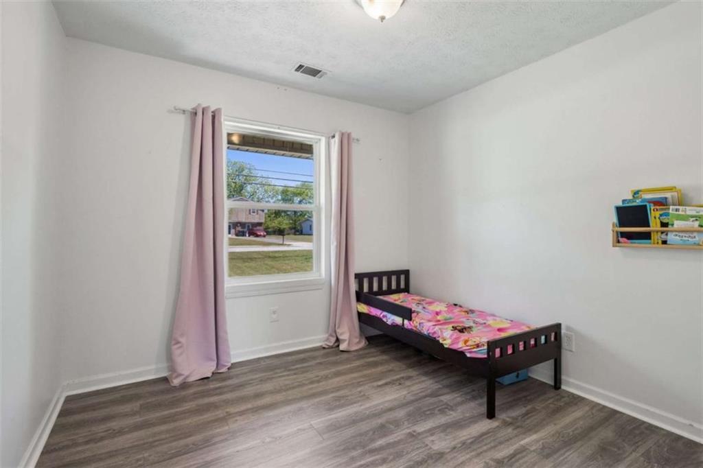 795 Tanner Road Dacula, GA 30019 - Photo 34 of 47 a bedroom with a bed and a window