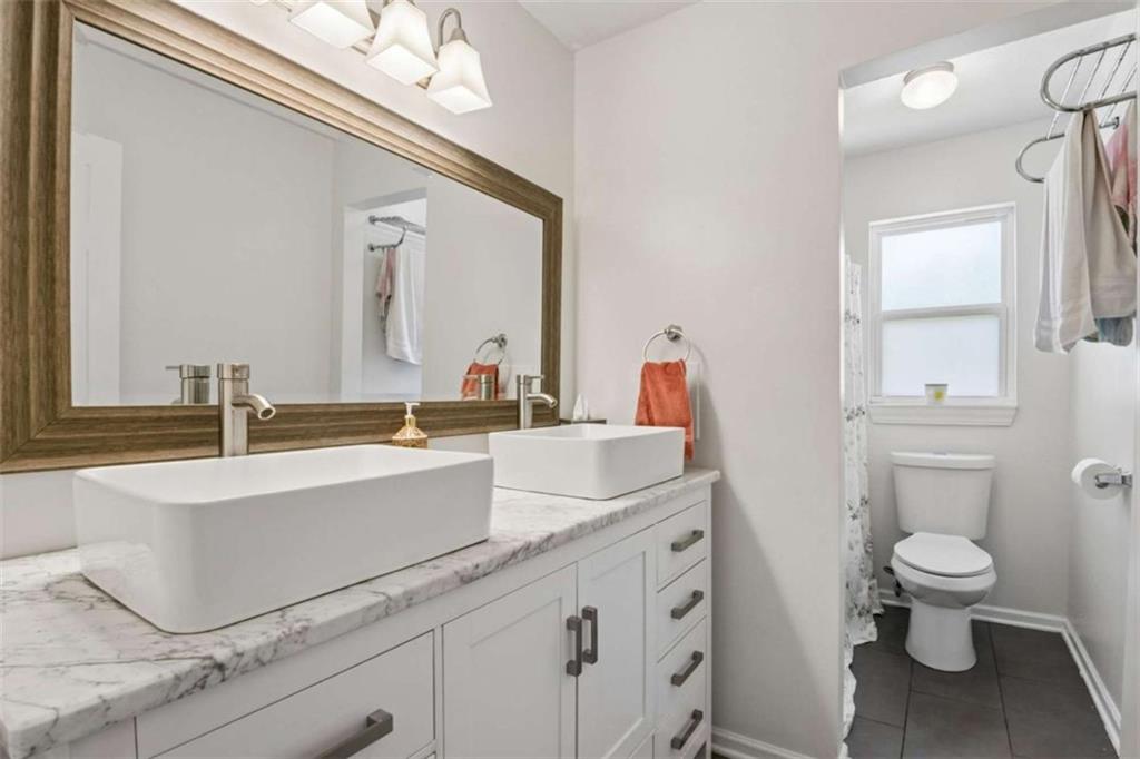795 Tanner Road Dacula, GA 30019 - Photo 37 of 47 a spacious bathroom with a sink toilet and a mirror