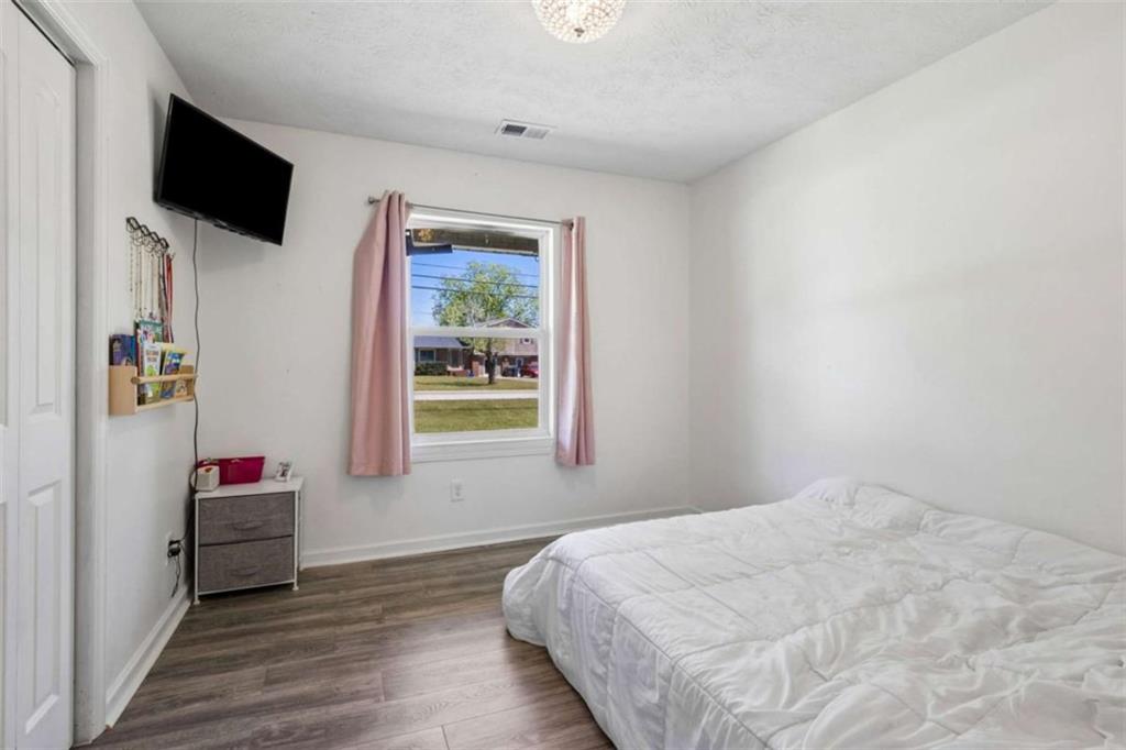 795 Tanner Road Dacula, GA 30019 - Photo 38 of 47 a bedroom with a bed and a flat screen tv