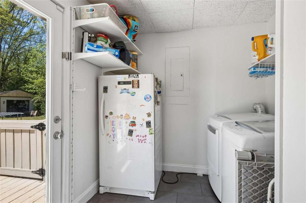 795 Tanner Road Dacula, GA 30019 - Photo 41 of 47 a storage room with wooden floor washer and dryer
