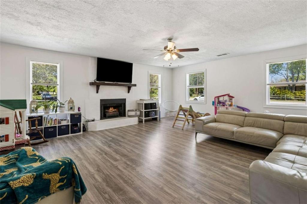 795 Tanner Road Dacula, GA 30019 - Photo 8 of 47 a living room with furniture a flat screen tv and a fireplace
