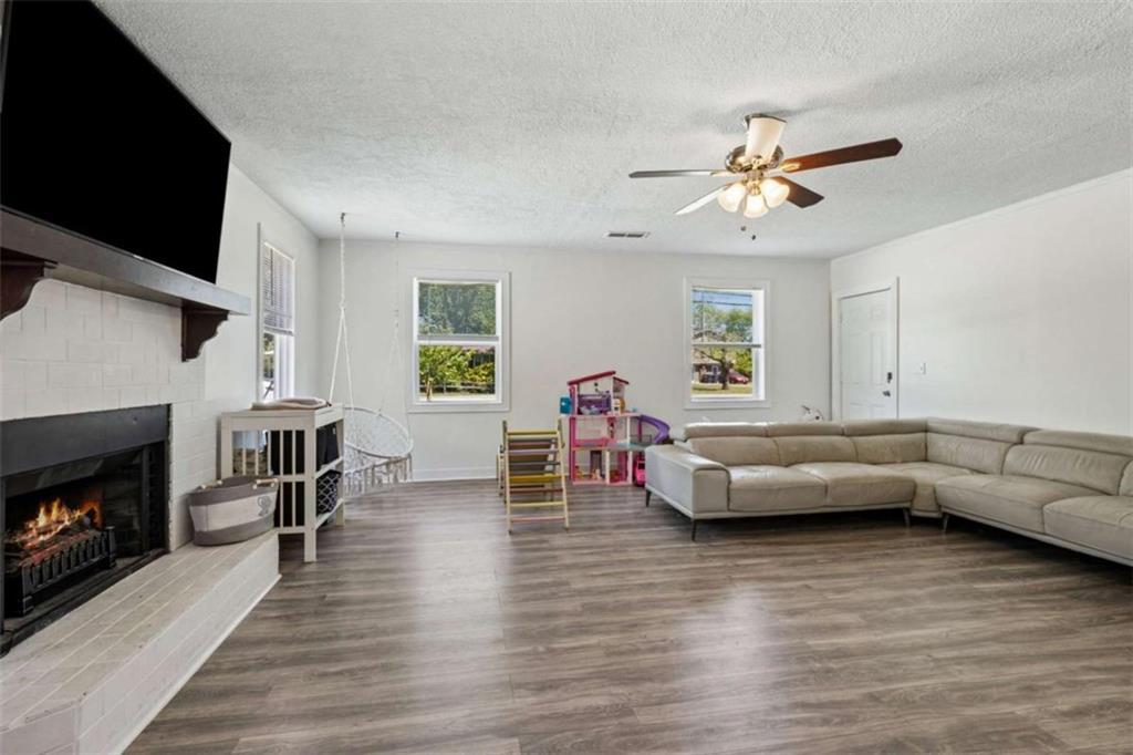 795 Tanner Road Dacula, GA 30019 - Photo 10 of 47 a living room with furniture flat screen tv and a fireplace