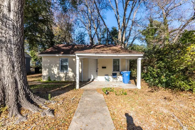 a view of a house with backyard porch and sitting area