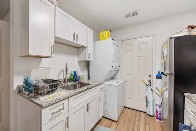 a kitchen with a sink a stove and cabinets