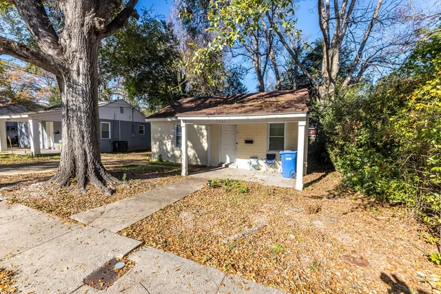 a front view of a house with a yard covered in snow
