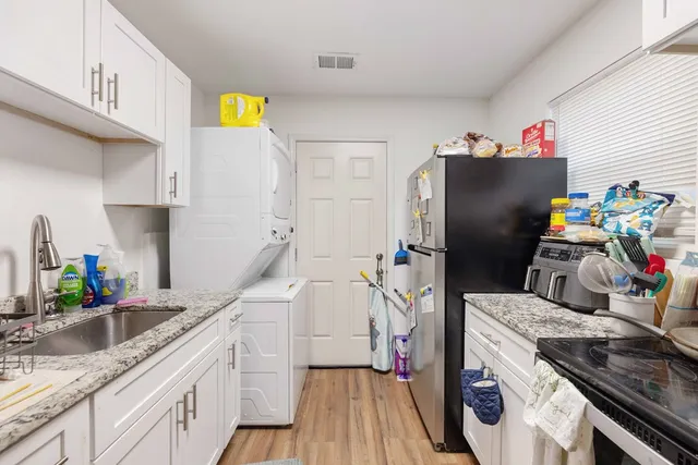 a kitchen with a sink and refrigerator
