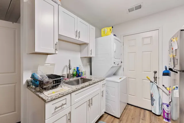 a kitchen with white cabinets and a sink