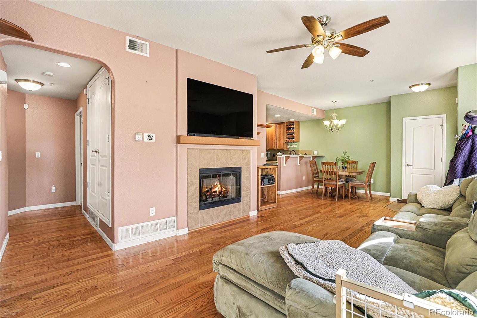 6293 Kilmer Loop, Unit 101 Golden, CO 80403 - Photo 5 of 17 a living room with furniture a fireplace and a flat screen tv
