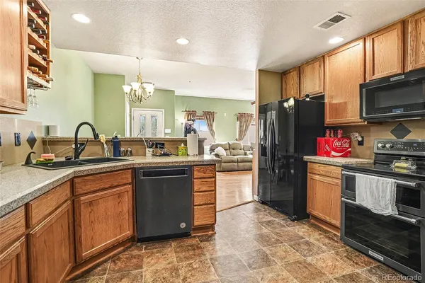 a kitchen with a sink stove and refrigerator