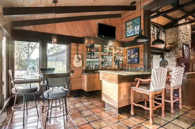 a room with pool table and windows