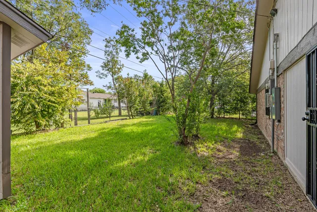 a front view of a house with a yard and trees