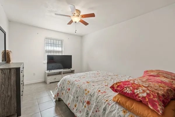 a bedroom with a bed and a television