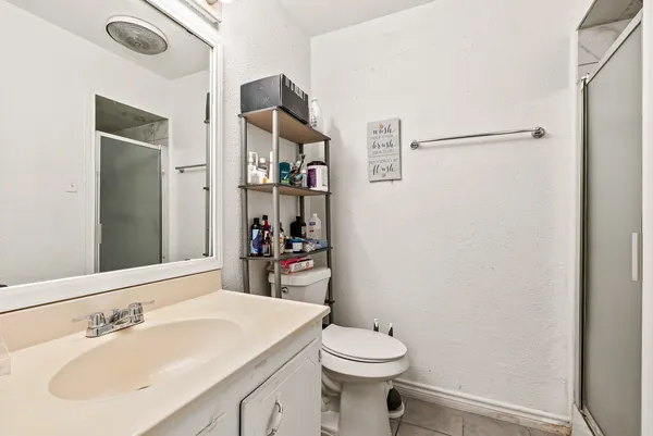 a bathroom with a sink toilet and shower