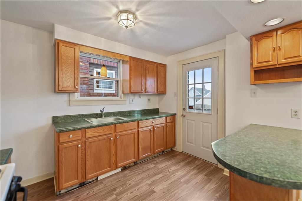 230 West Marigold Street Homestead, PA 15120 - Photo 11 of 50 a kitchen with a sink cabinets and window