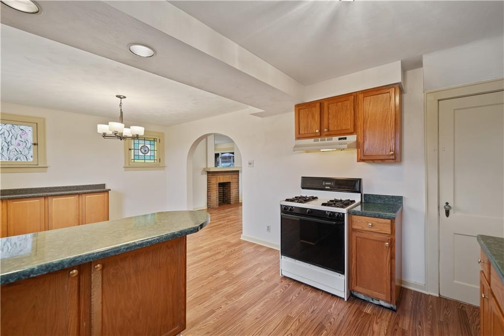230 West Marigold Street Homestead, PA 15120 - Photo 13 of 50 a kitchen with a stove and a sink wooden floor
