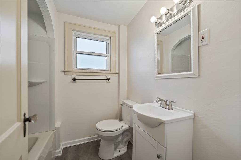 230 West Marigold Street Homestead, PA 15120 - Photo 18 of 50 a white toilet sitting next to a bathroom sink