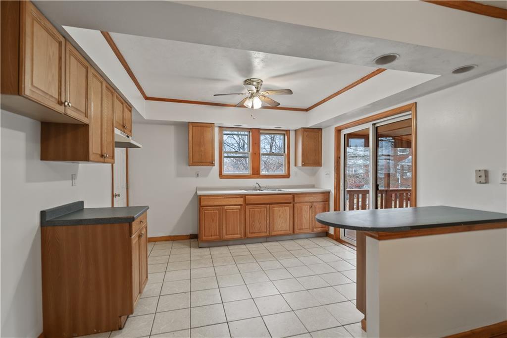 230 West Marigold Street Homestead, PA 15120 - Photo 31 of 50 a kitchen with stainless steel appliances granite countertop a stove a sink dishwasher and a microwave oven with cabinets