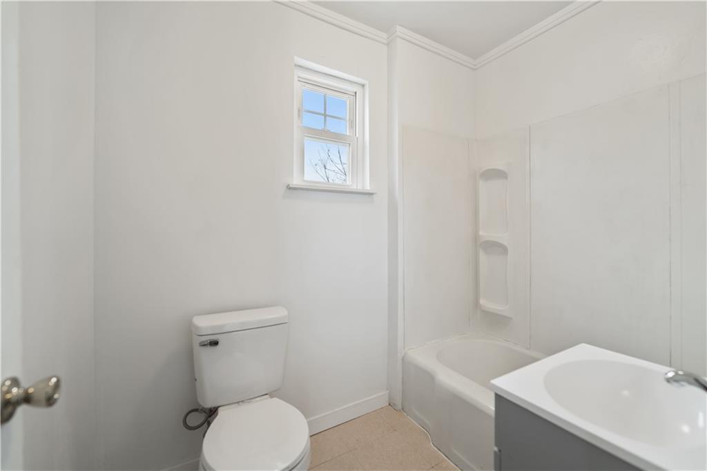230 West Marigold Street Homestead, PA 15120 - Photo 38 of 50 a white toilet sitting next to a bath tub