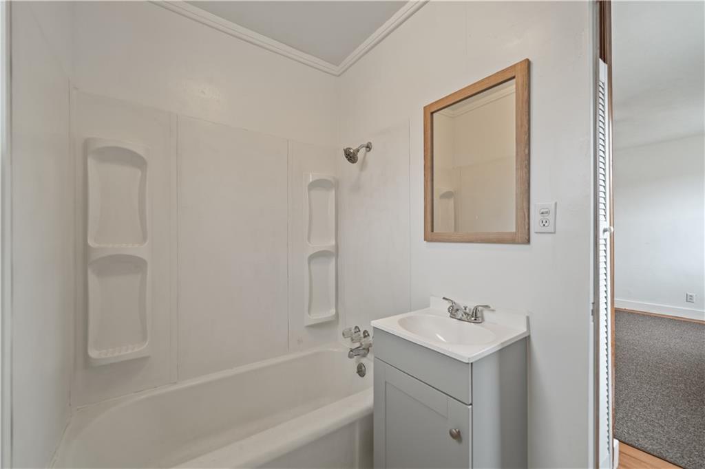 230 West Marigold Street Homestead, PA 15120 - Photo 39 of 50 a bathroom with a bathtub sink vanity and mirror