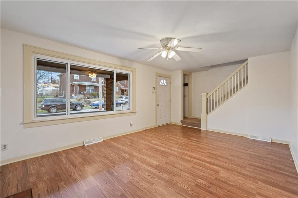 230 West Marigold Street Homestead, PA 15120 - Photo 4 of 50 a view of empty room with wooden floor and fan