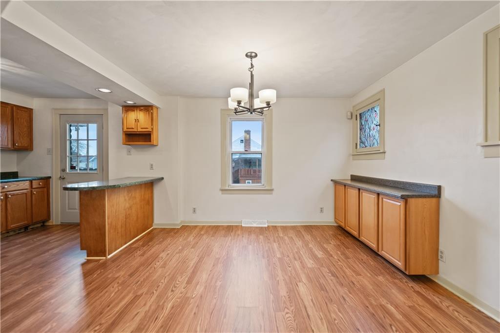 230 West Marigold Street Homestead, PA 15120 - Photo 7 of 50 a view of an empty room with window and wooden floor