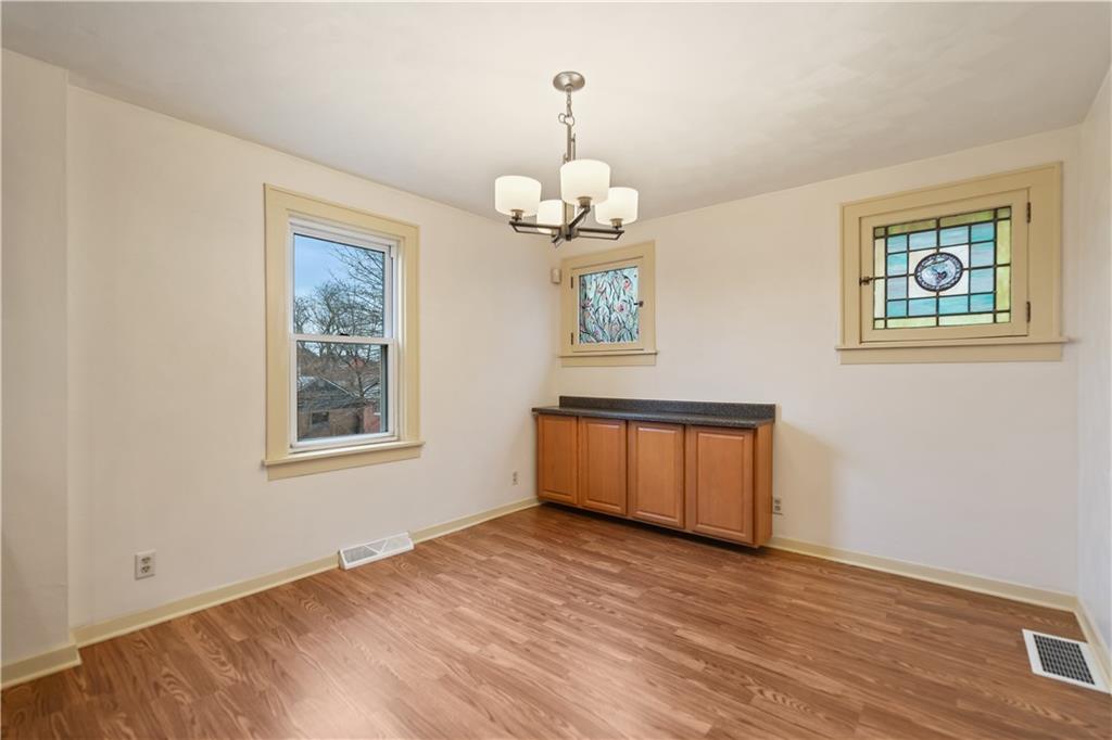 230 West Marigold Street Homestead, PA 15120 - Photo 8 of 50 a view of an empty room with a window and wooden floor