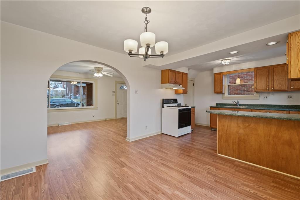 230 West Marigold Street Homestead, PA 15120 - Photo 9 of 50 a view of a kitchen with a sink and wooden floor