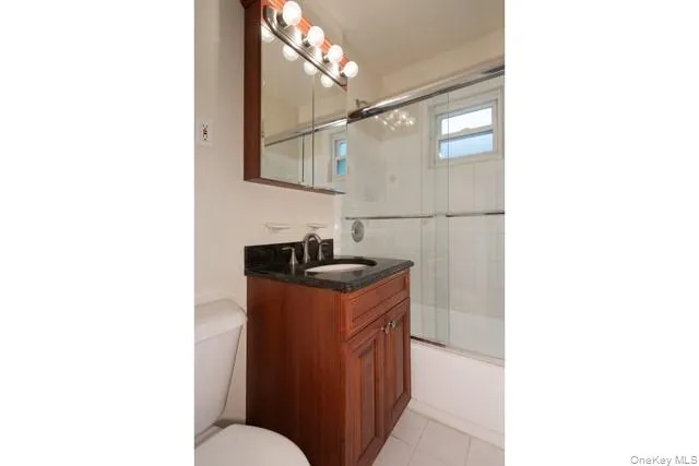 a kitchen with a sink and a mirror