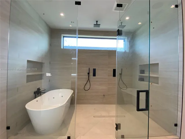 a bathroom with a bathtub and shower