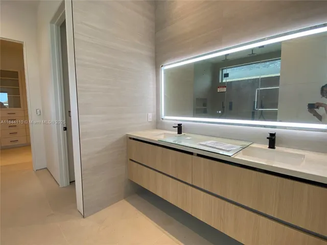 a bathroom with a double vanity sink and mirror