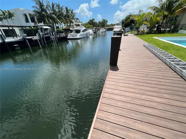 a view of a lake with boats and trees in the background