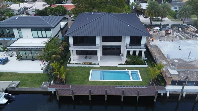 a view of a house with a swimming pool and a chairs
