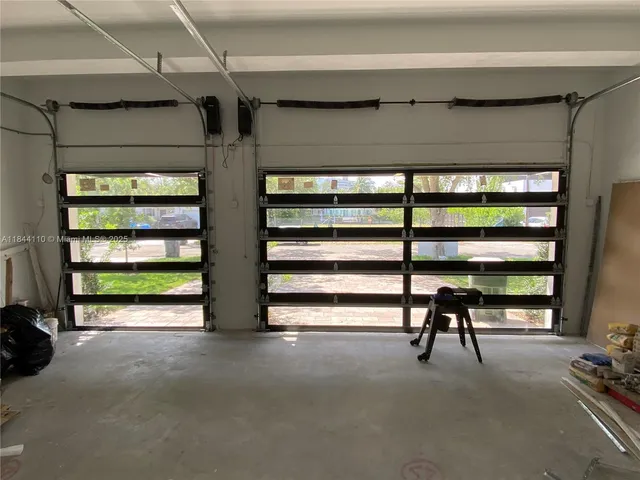 a view of game room with windows and stairs