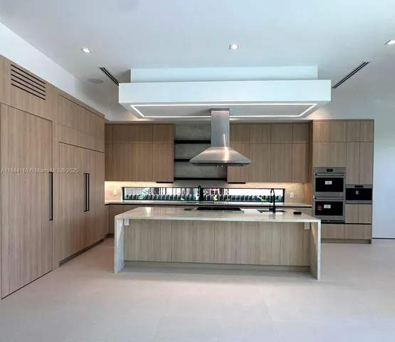 a kitchen with stainless steel appliances a sink stove and refrigerator