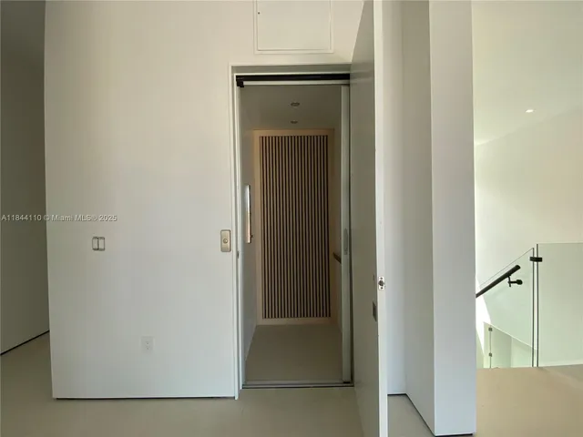 a view of a bathroom from a corridor