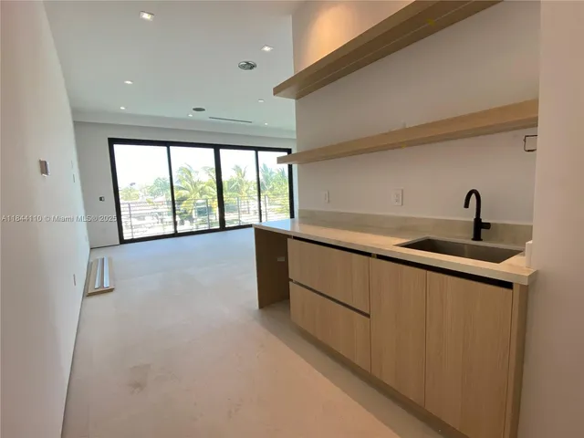 a kitchen with a sink and large window