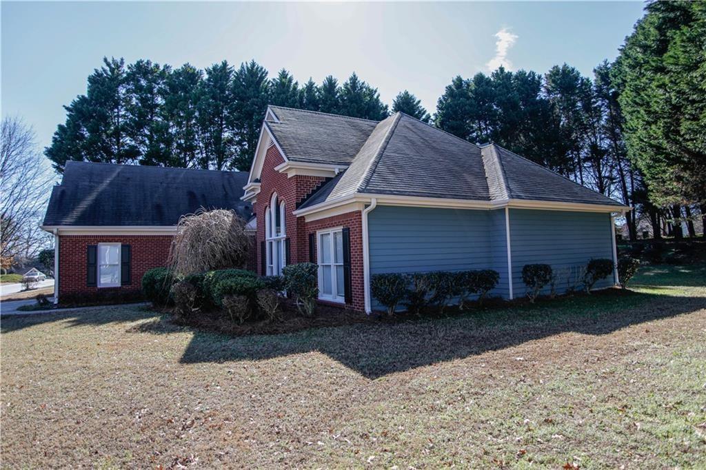 3875 Spring Manor Court Loganville, GA 30052 - Photo 3 of 23 a front view of a house with garden