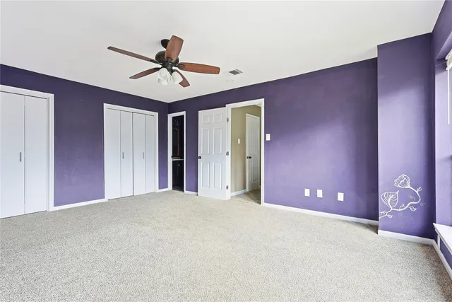 a view of a livingroom with a ceiling fan and window