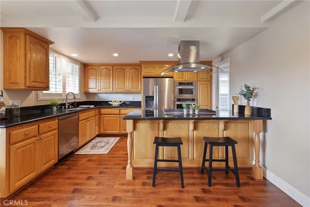 a kitchen with stainless steel appliances granite countertop a sink and cabinets