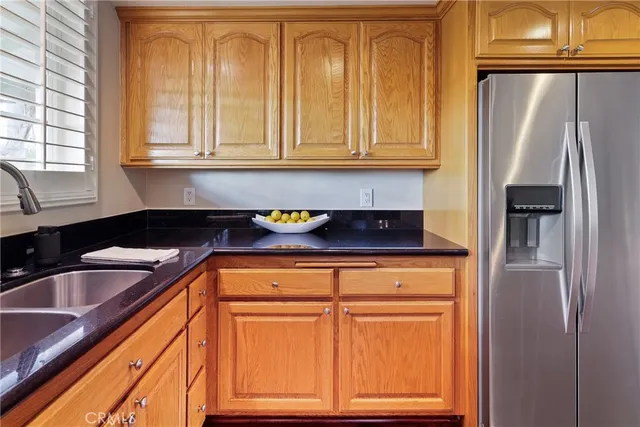 a kitchen with granite countertop stainless steel appliances and wooden cabinets