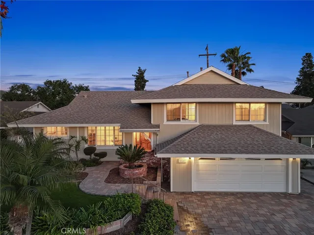 a view of a house with backyard sitting area and garden