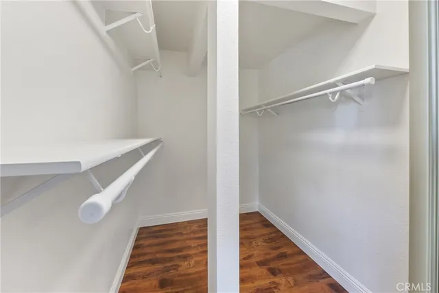 a bathroom with a granite countertop toilet a sink and a mirror